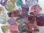 rainbow of raw gemstones 